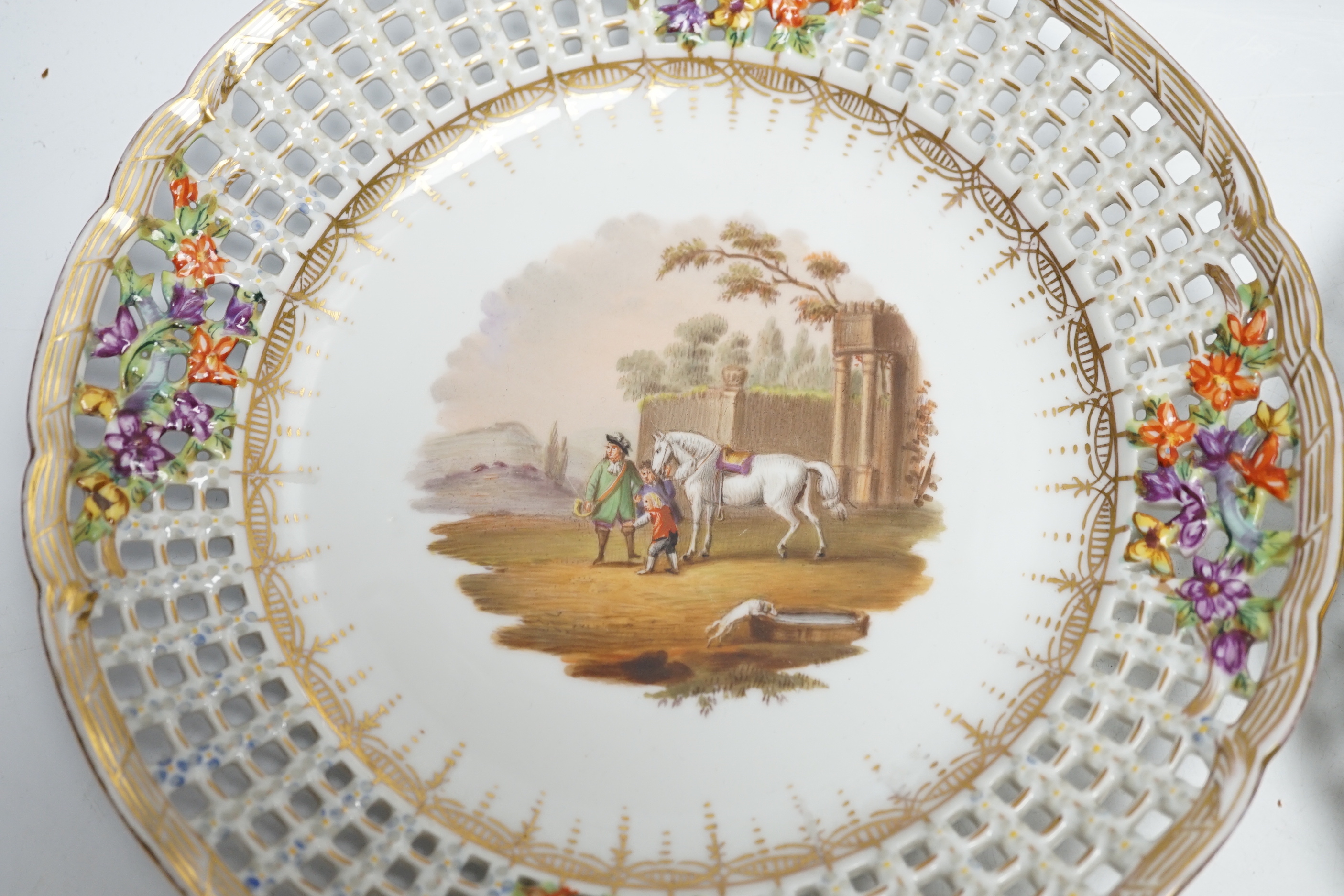 A set of four Dresden porcelain cabinet plates decorated with landscapes, 22cm diameter